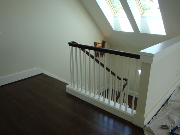 AFTER: Finished staircase with Oregon Black Walnut railings and recycled White Oak treads at the NW Portland home.