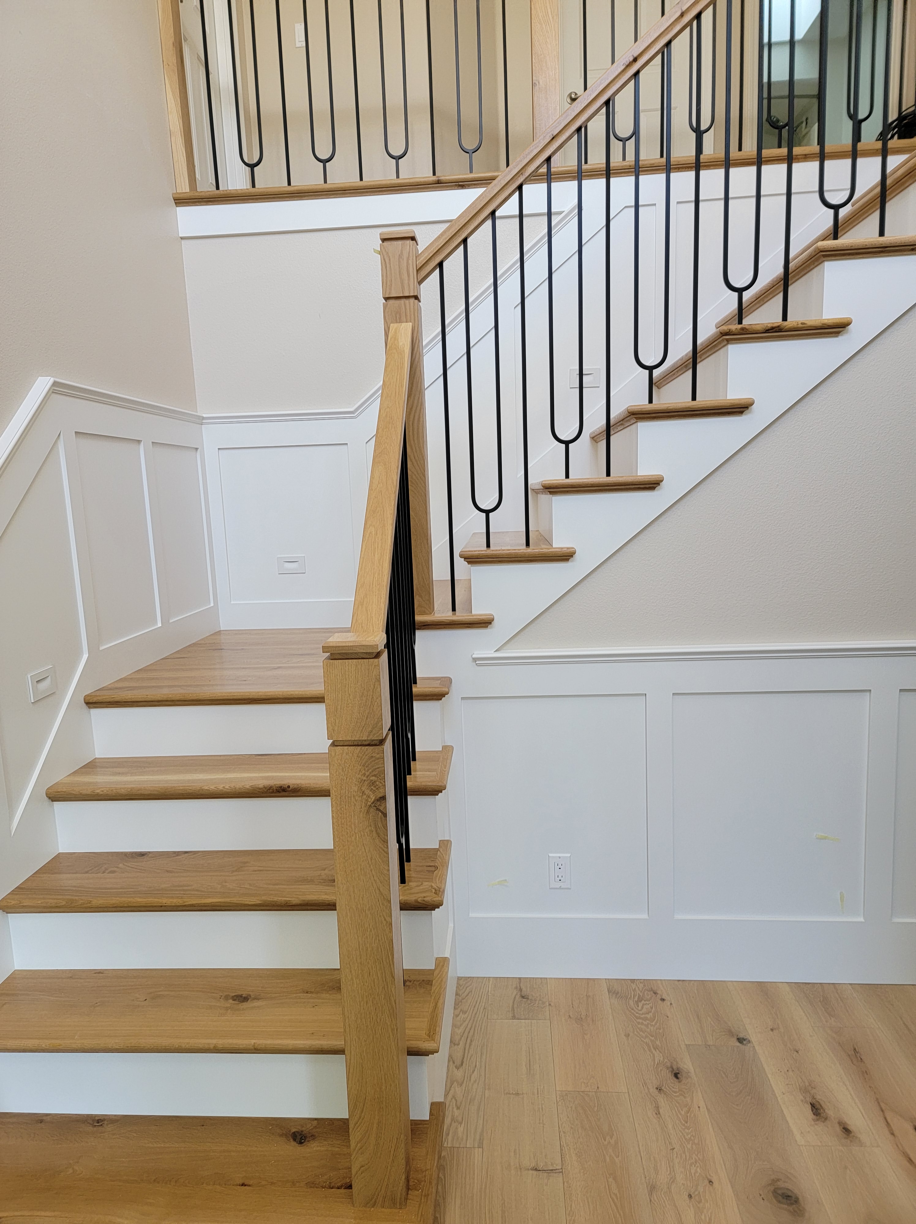 Our client did her research and designed her staircase. We added wainscoting in the entry to compliment her design.