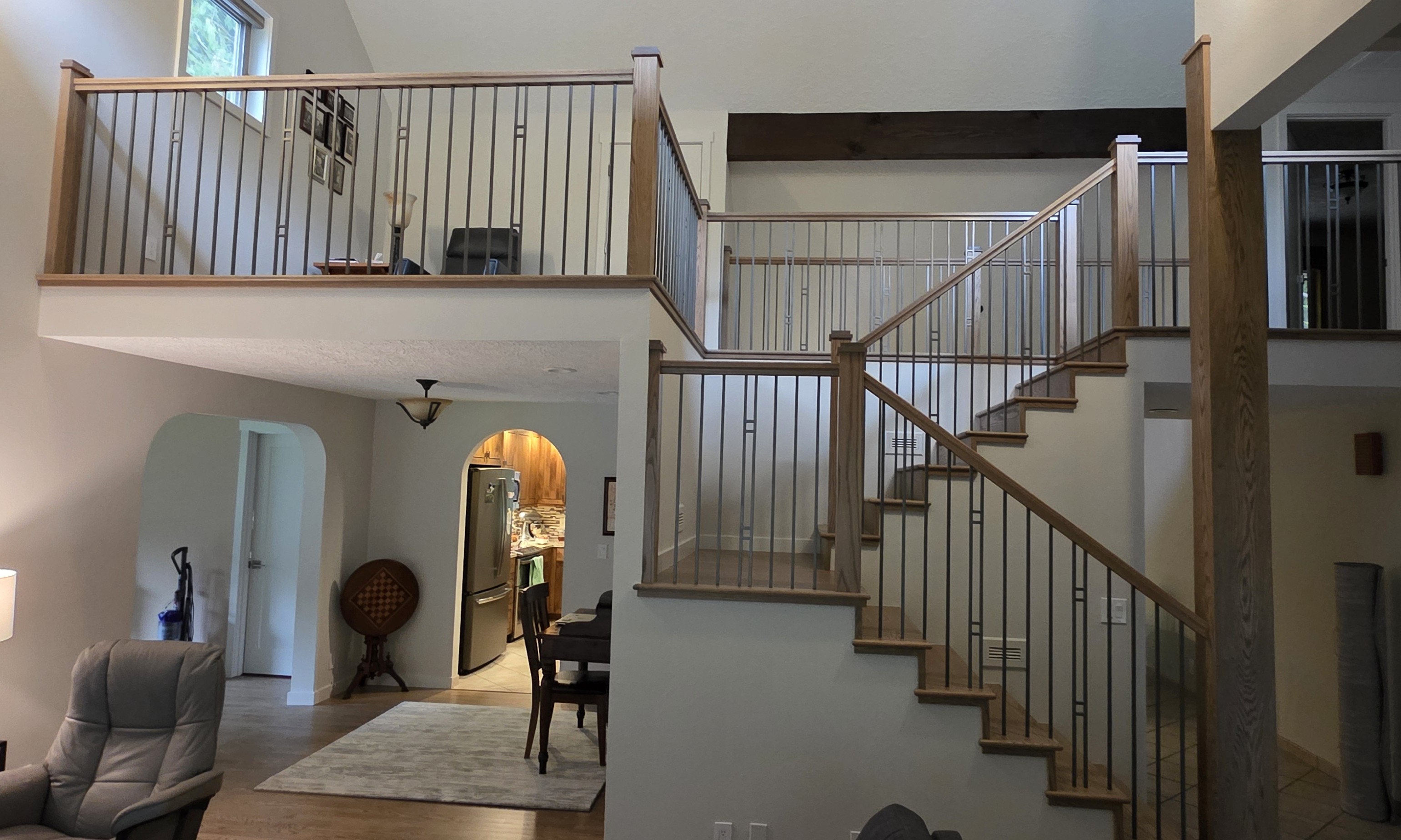 The client was tired of the deck style railing look. We used Red Oak parts and custom powder coated iron balusters to change the look.