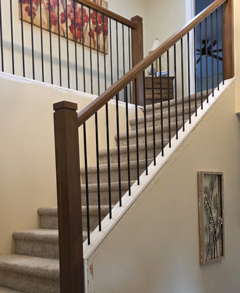 AFTER: Staircase with premium Alder posts and railings matched to cabinet stain color at the Felida home.