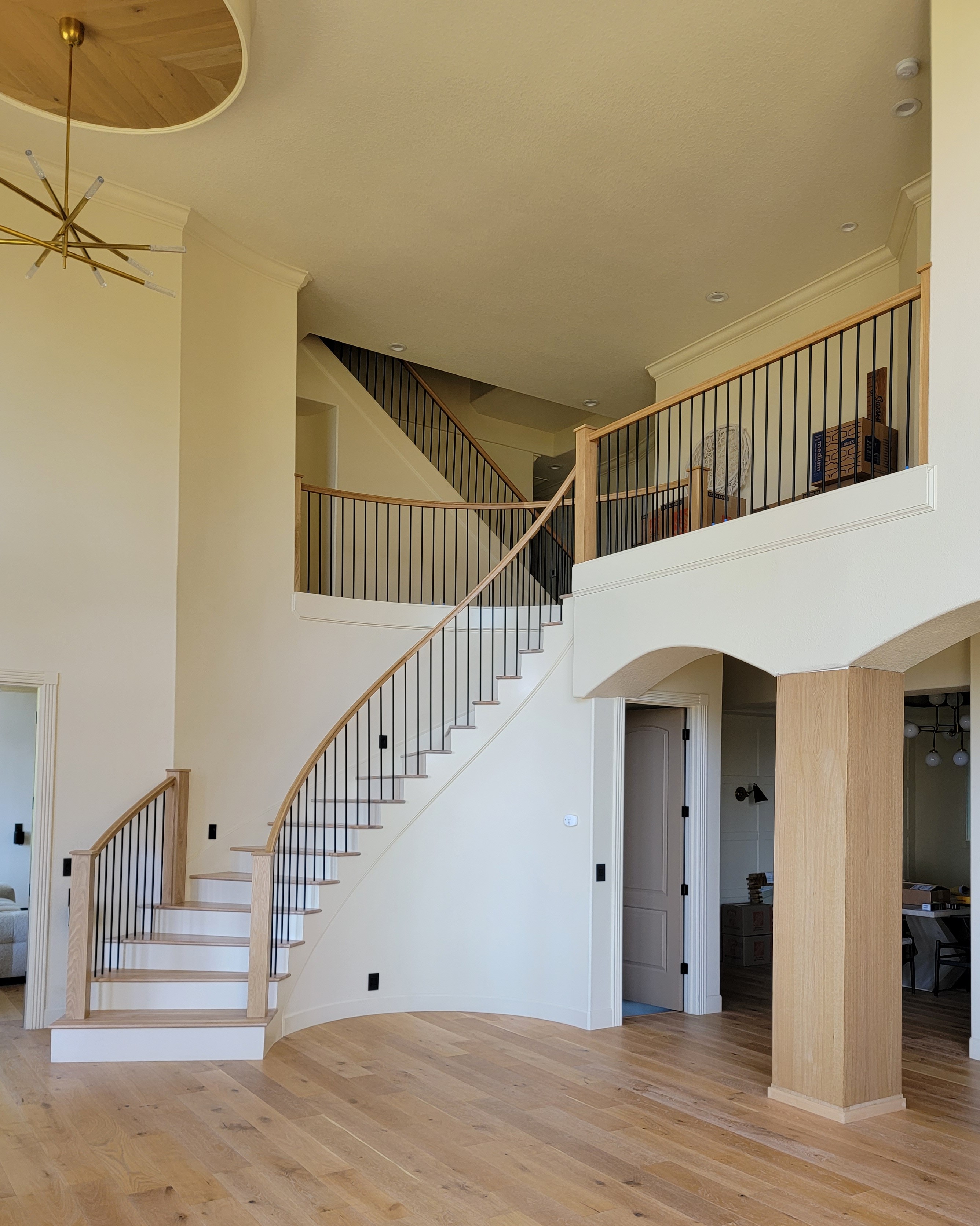 Client hired our company to replace the metal curved stair and ledge railings. We bent oak railings, oak posts and metal iron balusters for the replacement. We also manufactured and installed column wraps. All wood parts were pre stained and sealed in our shop.