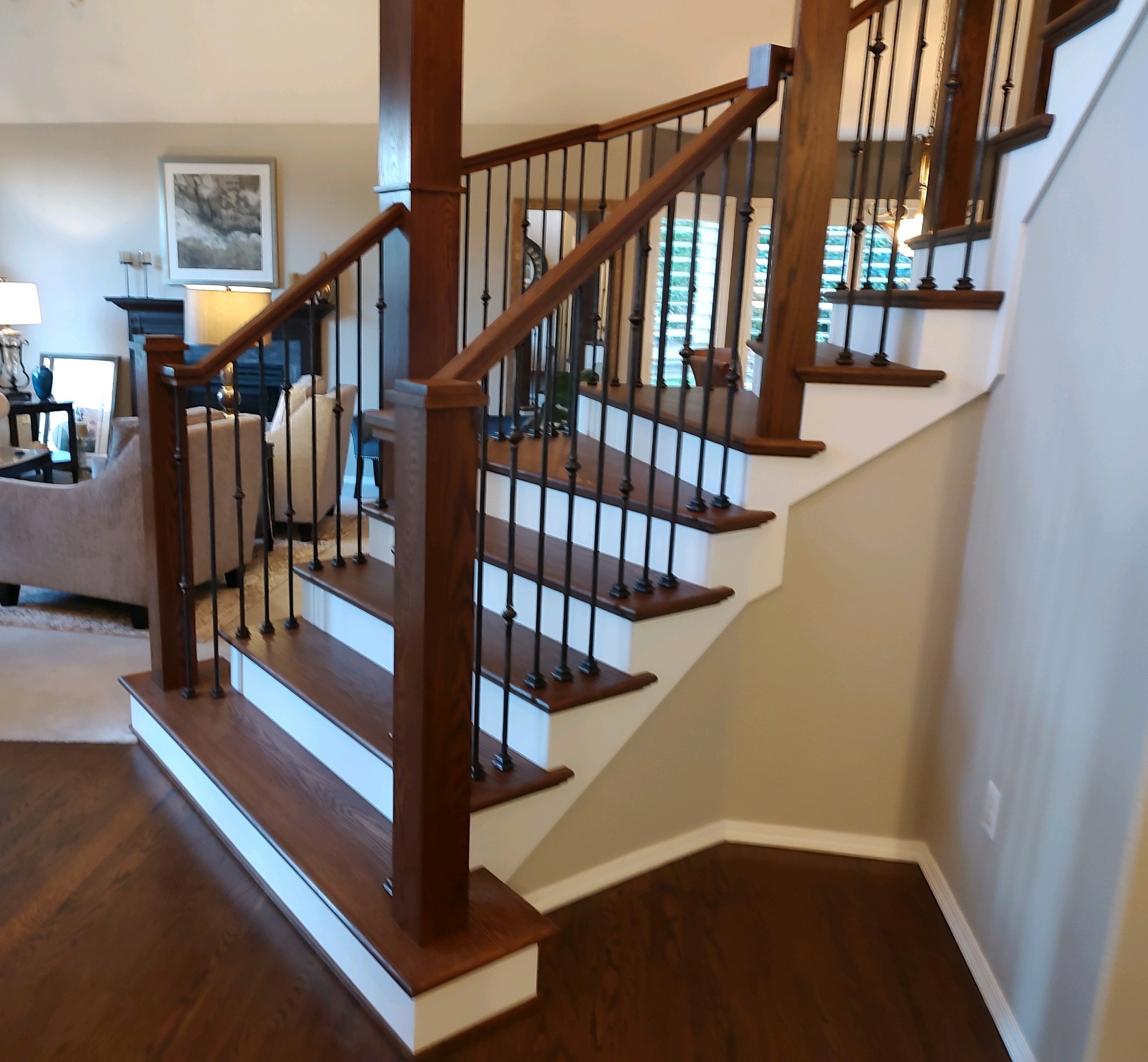 This was a real challenge for our company. We removed all the pony walls to give the staircase an open look. All the wood parts were manufactured, stained and sealed before installation.