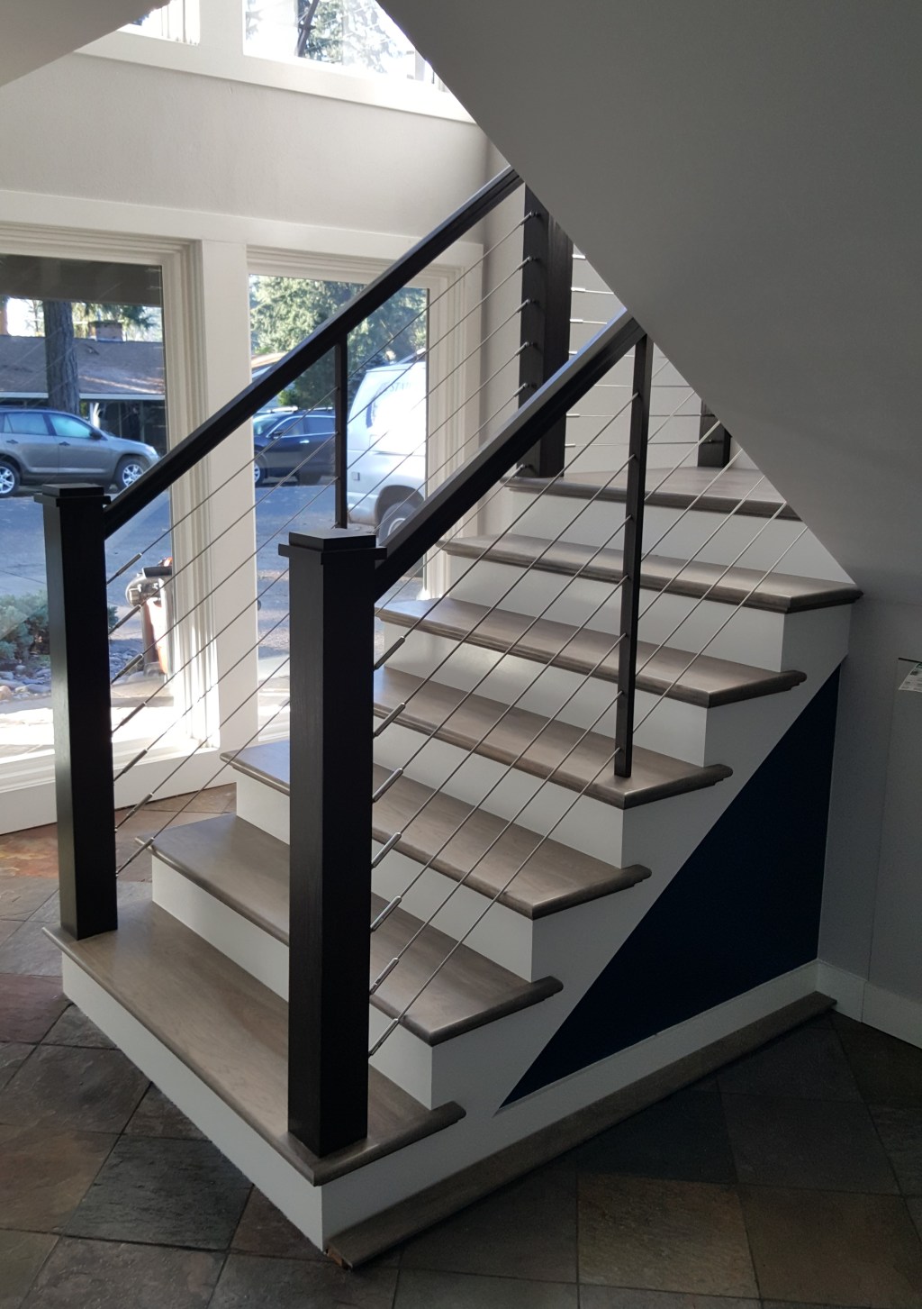 AFTER: Newly framed staircase with Hickory posts, railings, and stainless steel cable at the South Vancouver home.